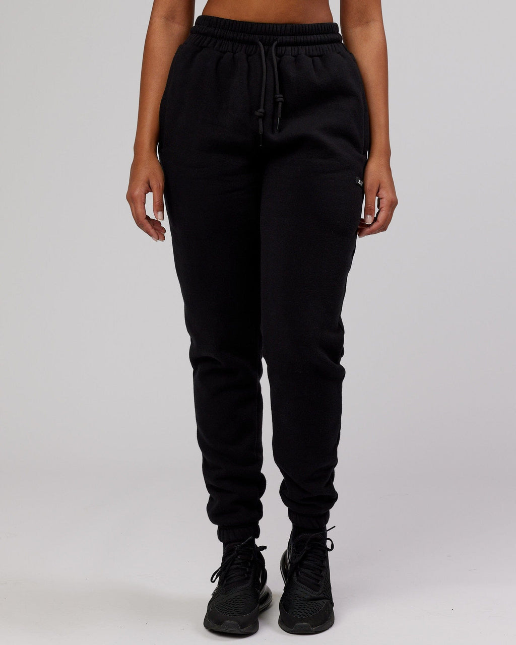 Model wearing Unisex Iconic Track Pant - Black