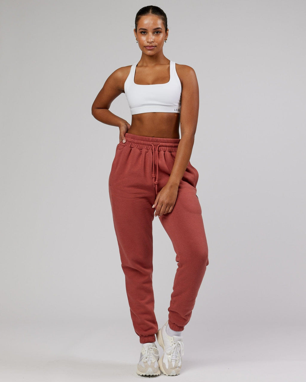 Model wearing Unisex Iconic Track Pant - Marsala