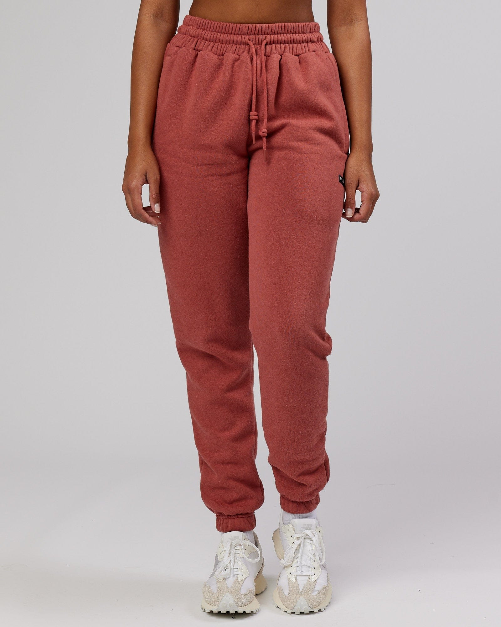Model wearing Unisex Iconic Track Pant - Marsala