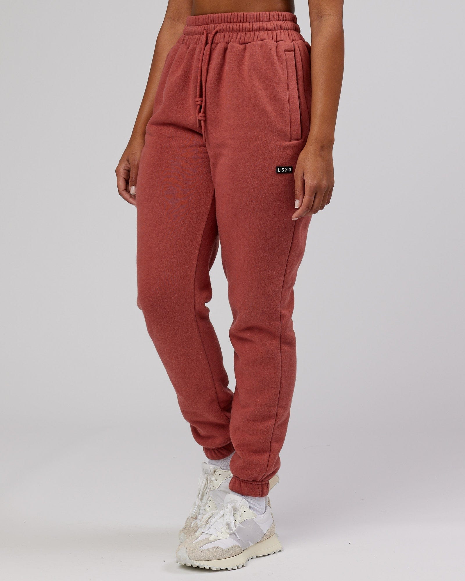 Model wearing Unisex Iconic Track Pant - Marsala