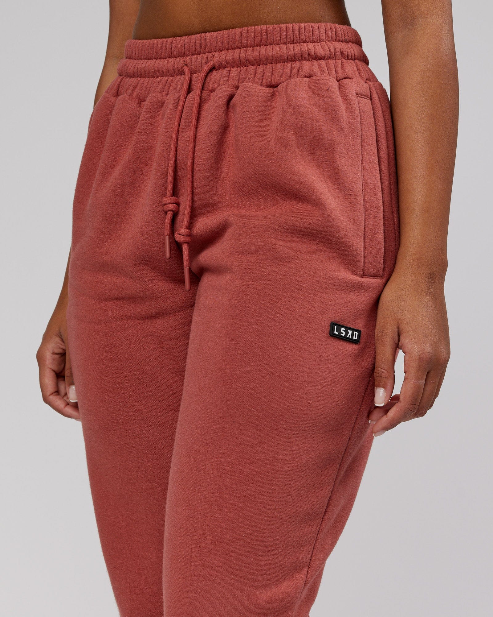 Model wearing Unisex Iconic Track Pant - Marsala