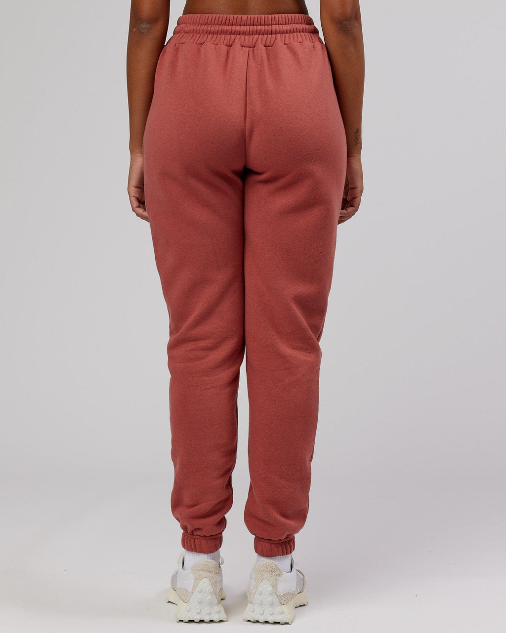 Model wearing Unisex Iconic Track Pant - Marsala
