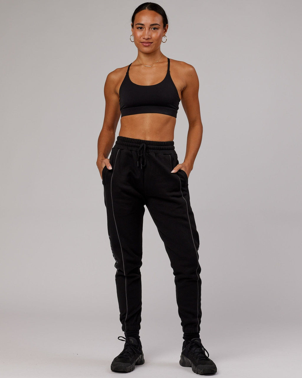 Model wearing Unisex Impact Trackpants - Black-Grey