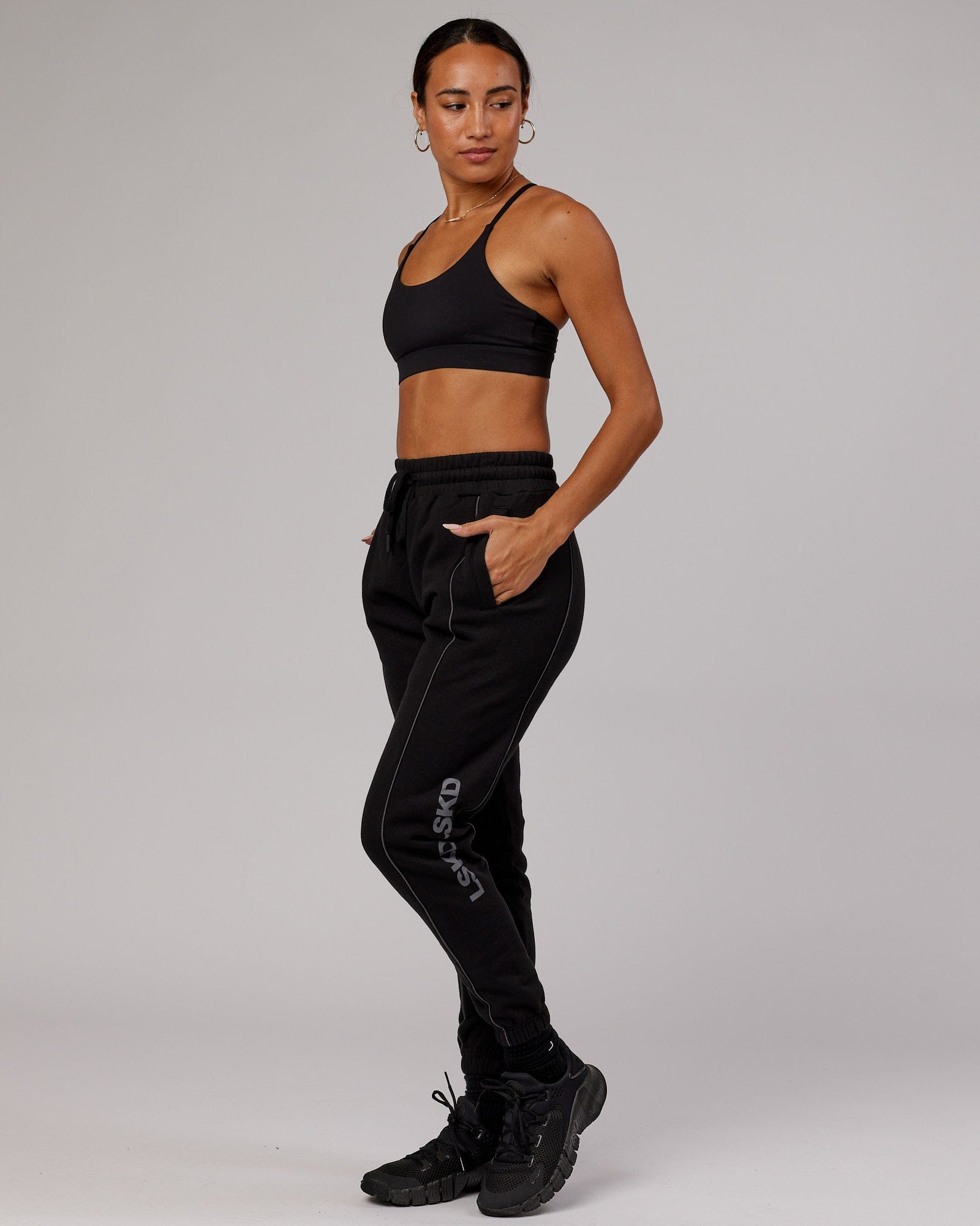 Model wearing Unisex Impact Trackpants - Black-Grey