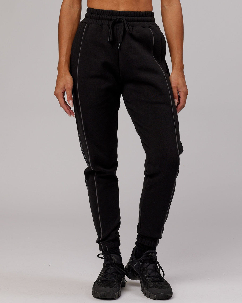 Model wearing Unisex Impact Trackpants - Black-Grey