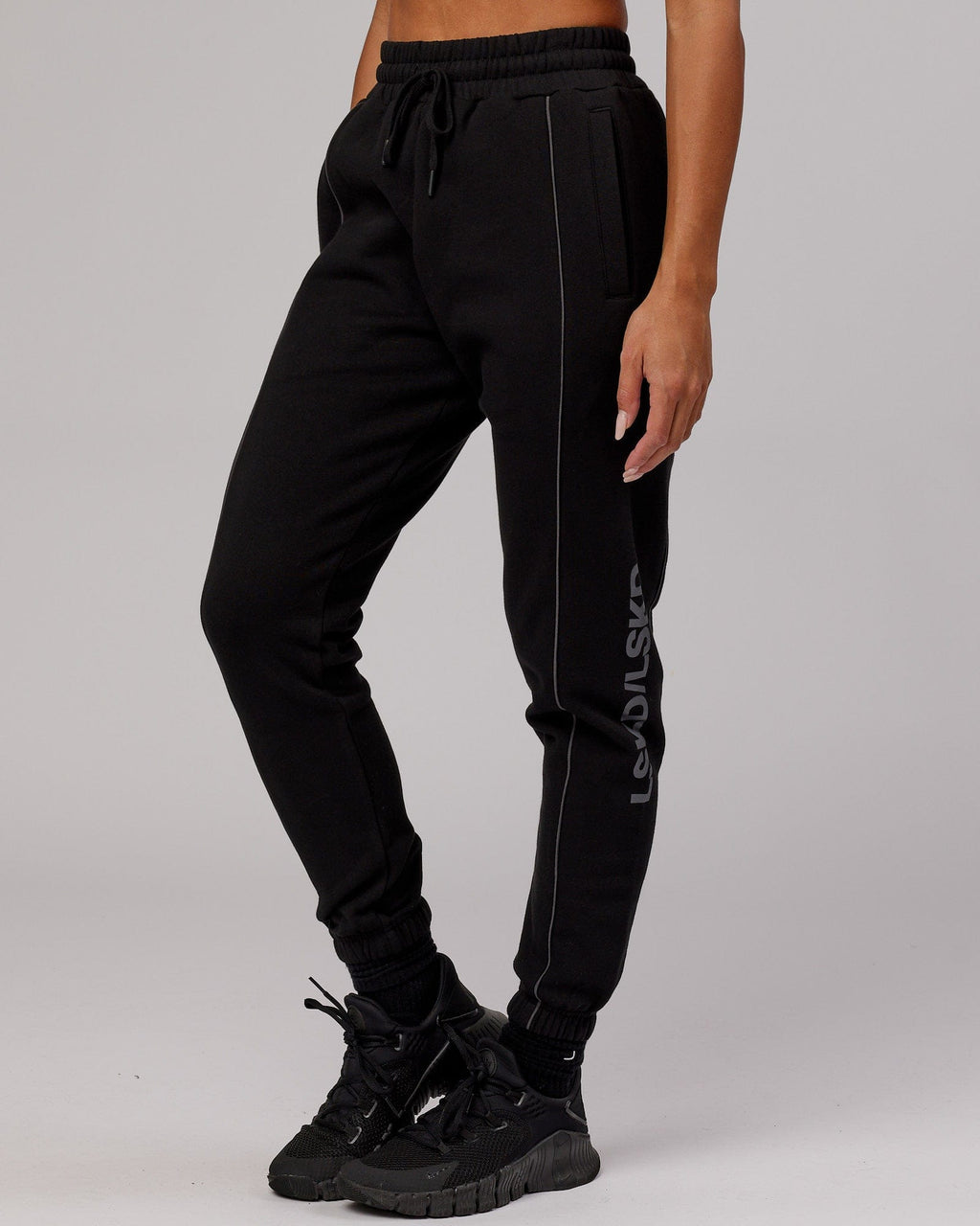 Model wearing Unisex Impact Trackpants - Black-Grey