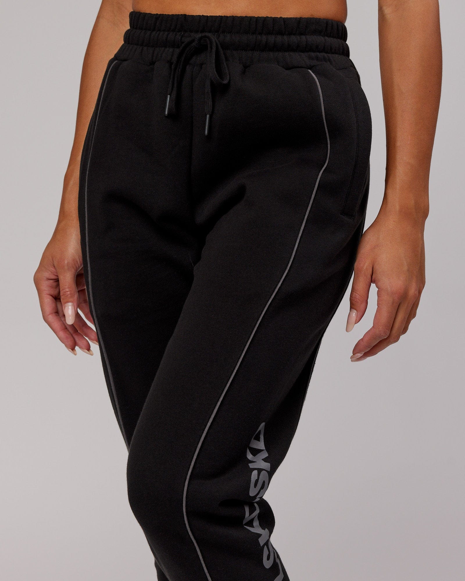 Model wearing Unisex Impact Trackpants - Black-Grey