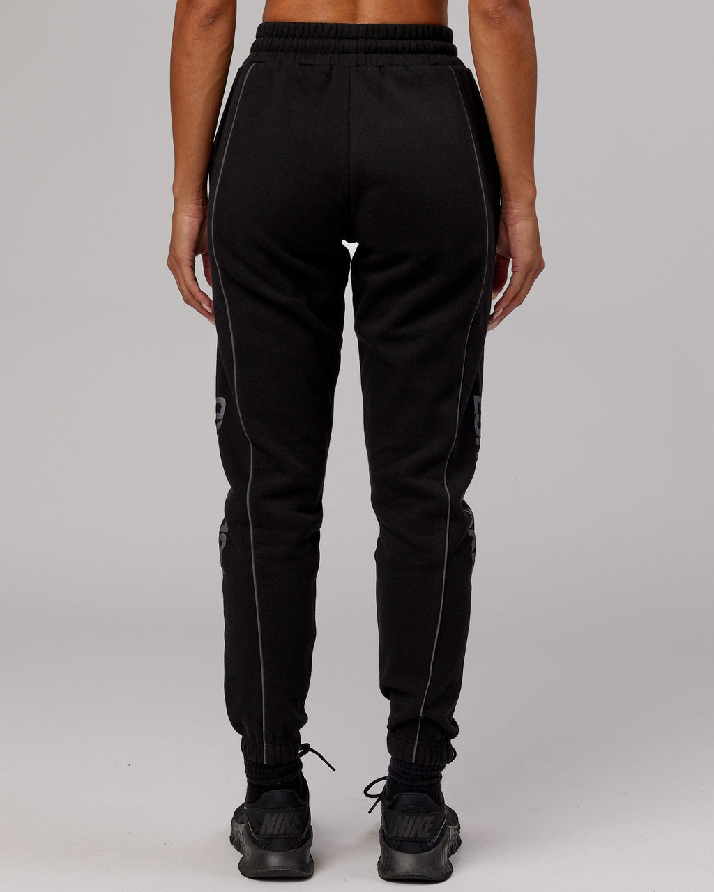 Model wearing Unisex Impact Trackpants - Black-Grey