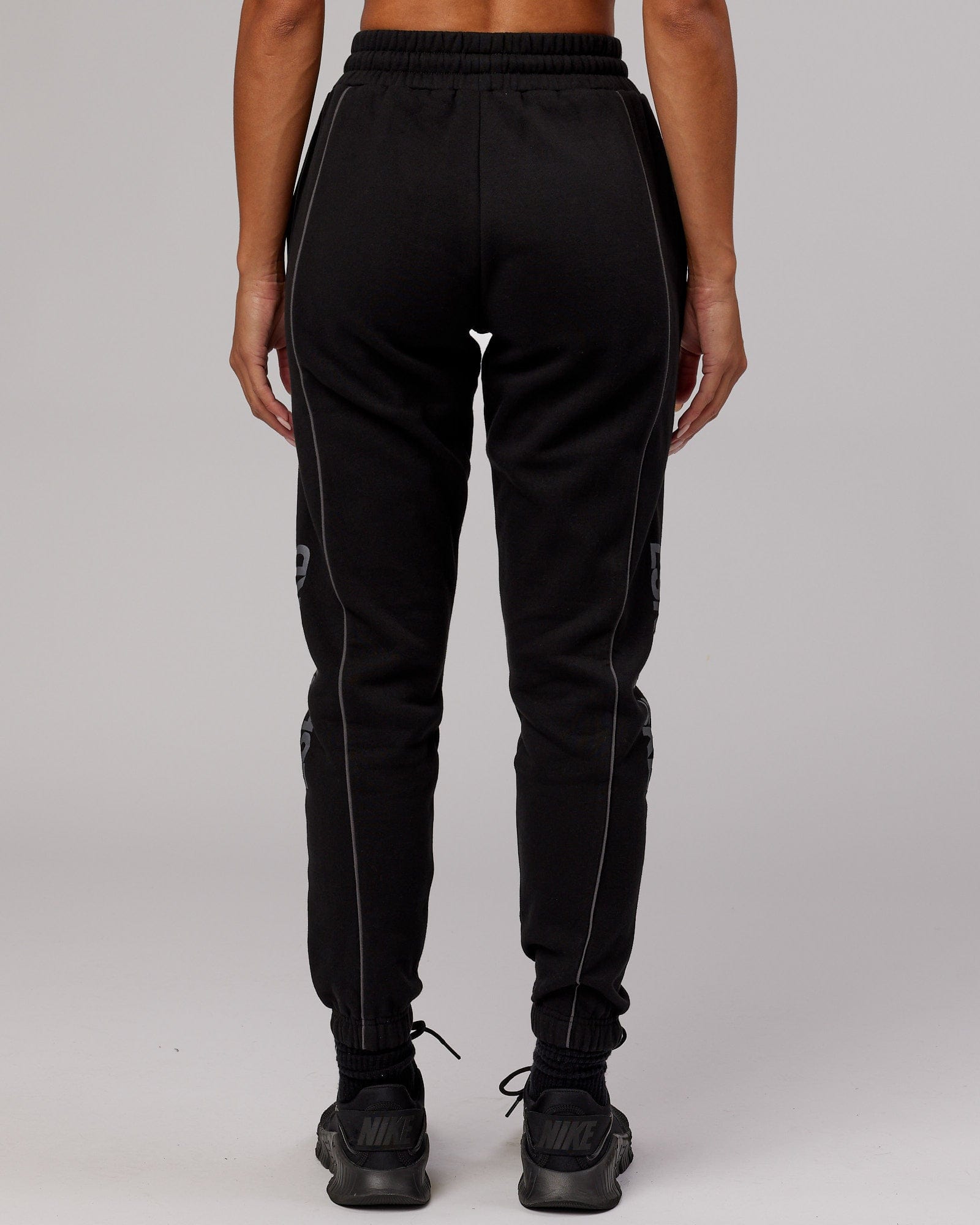 Model wearing Unisex Impact Trackpants - Black-Grey