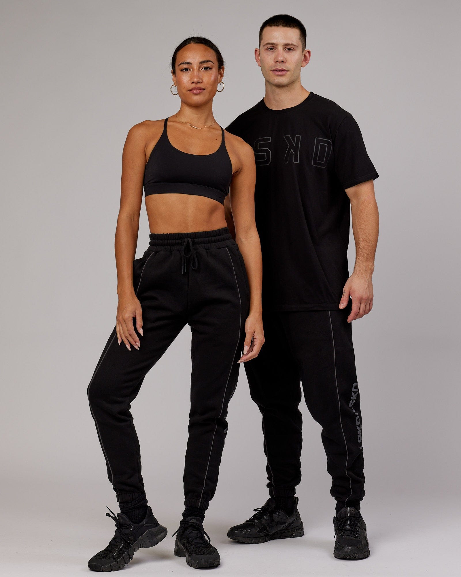 Model wearing Unisex Impact Trackpants - Black-Grey