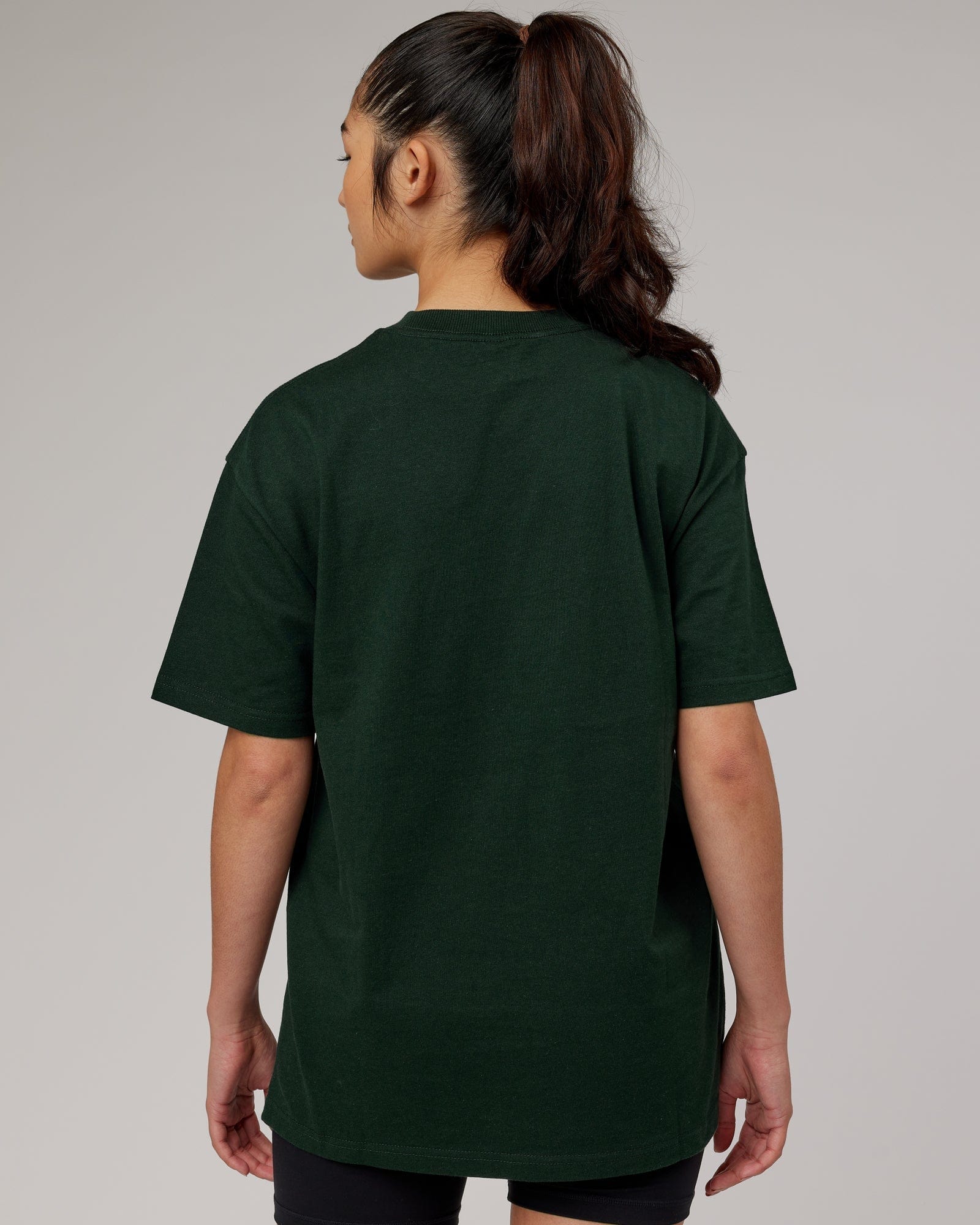 Model wearing Unisex Stacks Up Heavyweight Oversize Tee - Forest