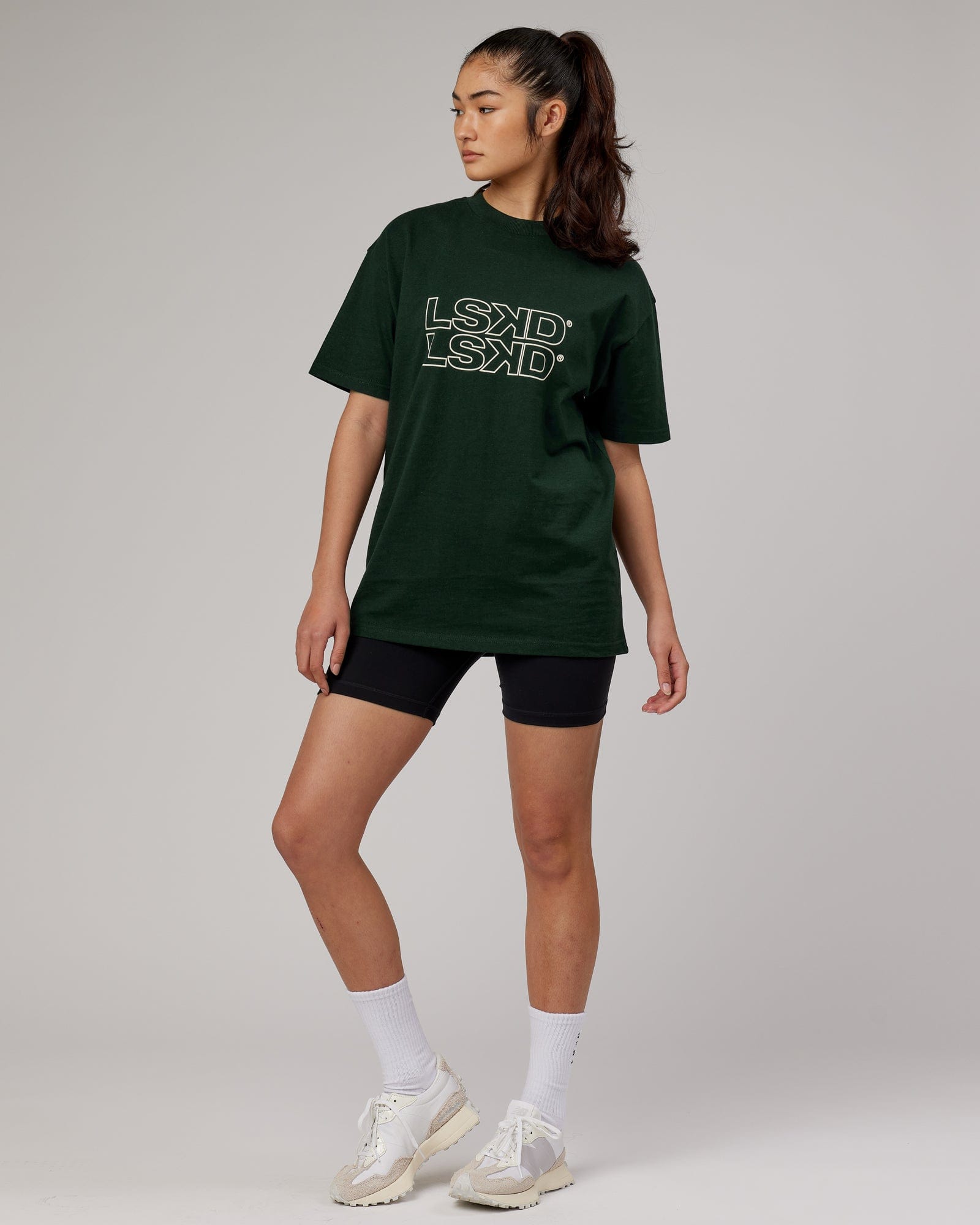 Model wearing Unisex Stacks Up Heavyweight Oversize Tee - Forest