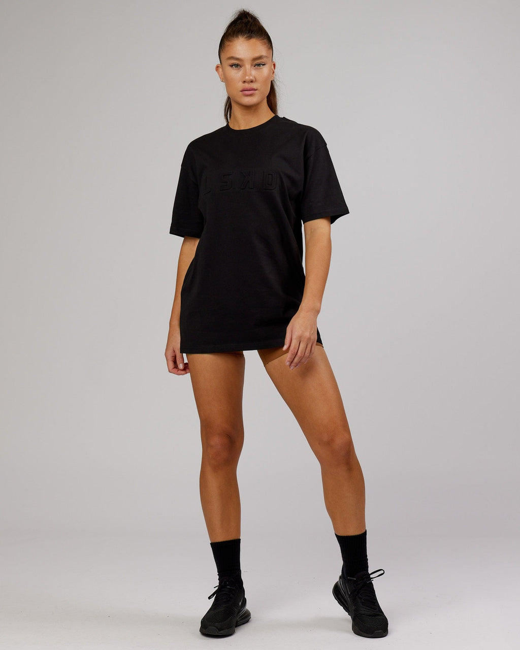 Model wearing Unisex Stamped Heavyweight Tee Oversize - Black