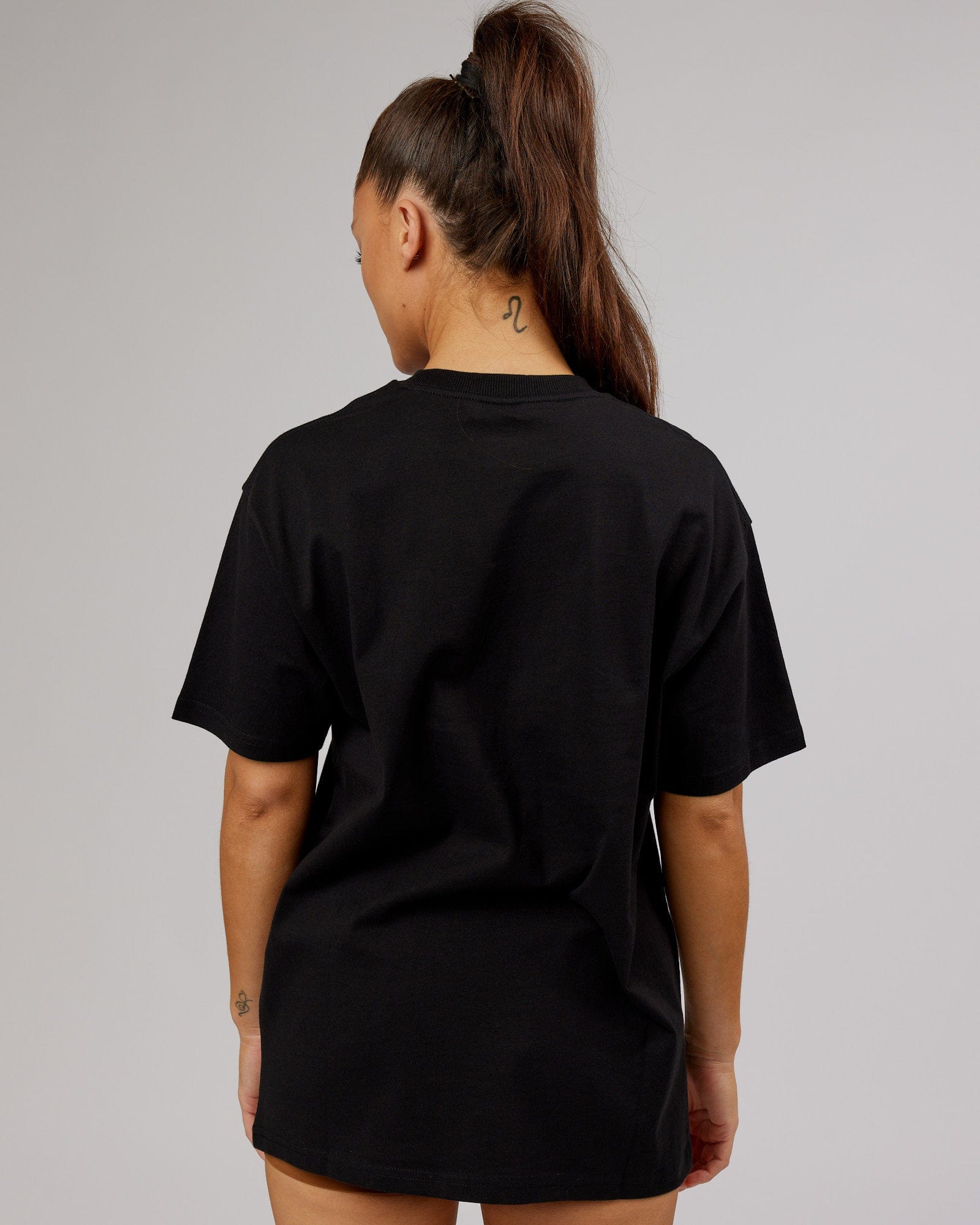 Model wearing Unisex Stamped Heavyweight Tee Oversize - Black