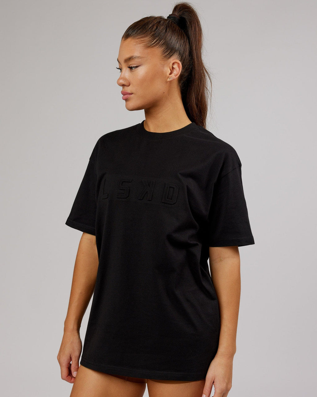 Model wearing Unisex Stamped Heavyweight Tee Oversize - Black