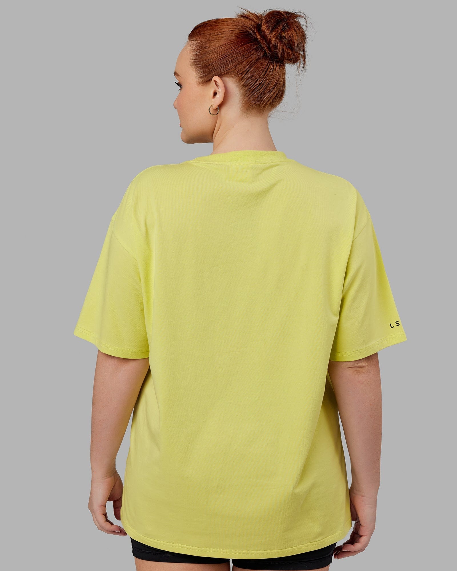 Model wearing Unisex Strive FLXCotton Tee Oversize - Citrus Green