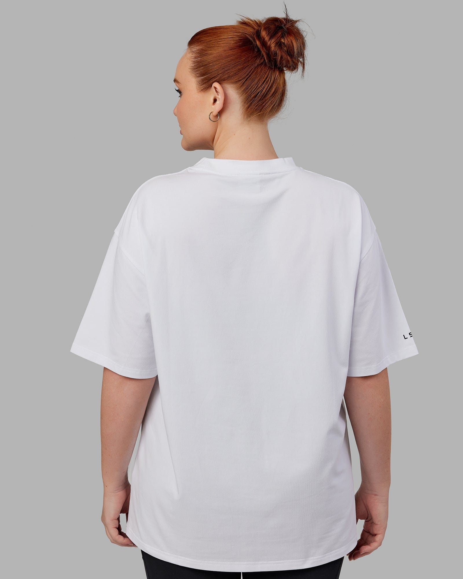 Model wearing Unisex Strive FLXCotton Tee Oversize - White