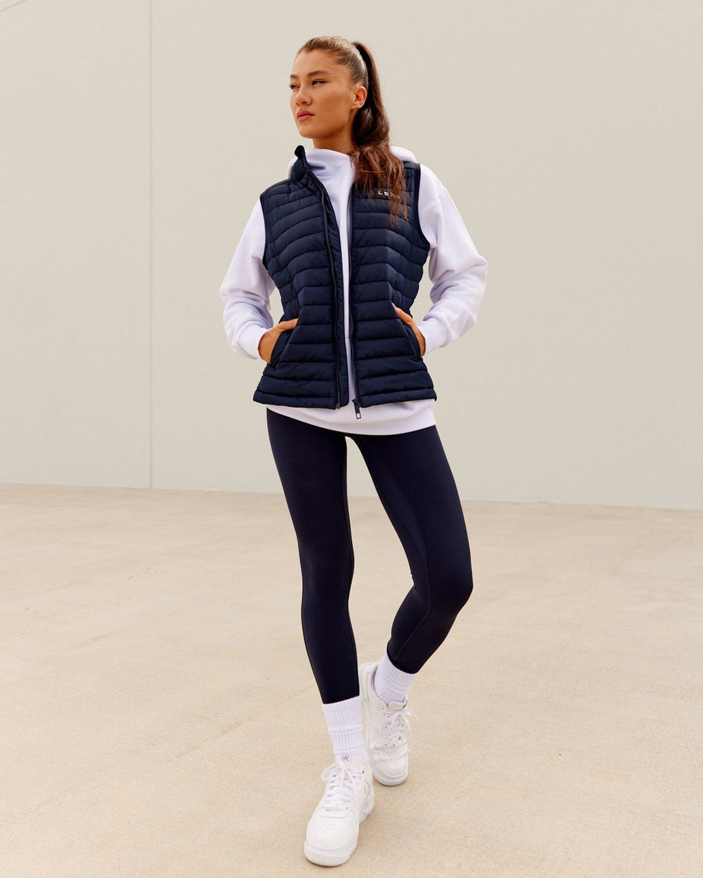 Model wearing Uplift Puffer Vest - Navy
