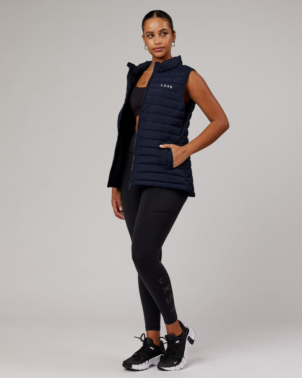 Model wearing Uplift Puffer Vest - Navy