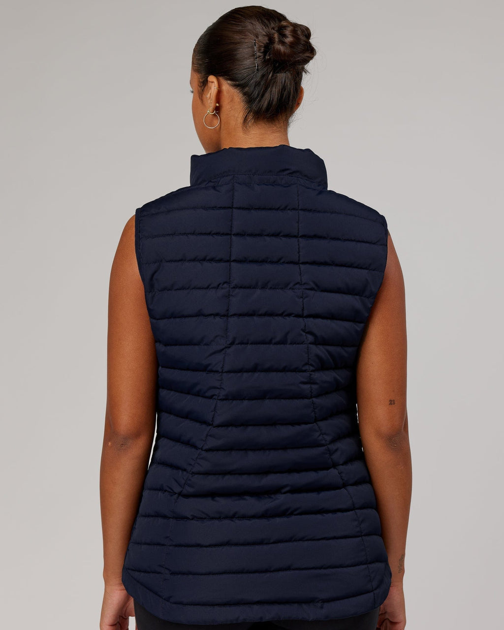 Model wearing Uplift Puffer Vest - Navy