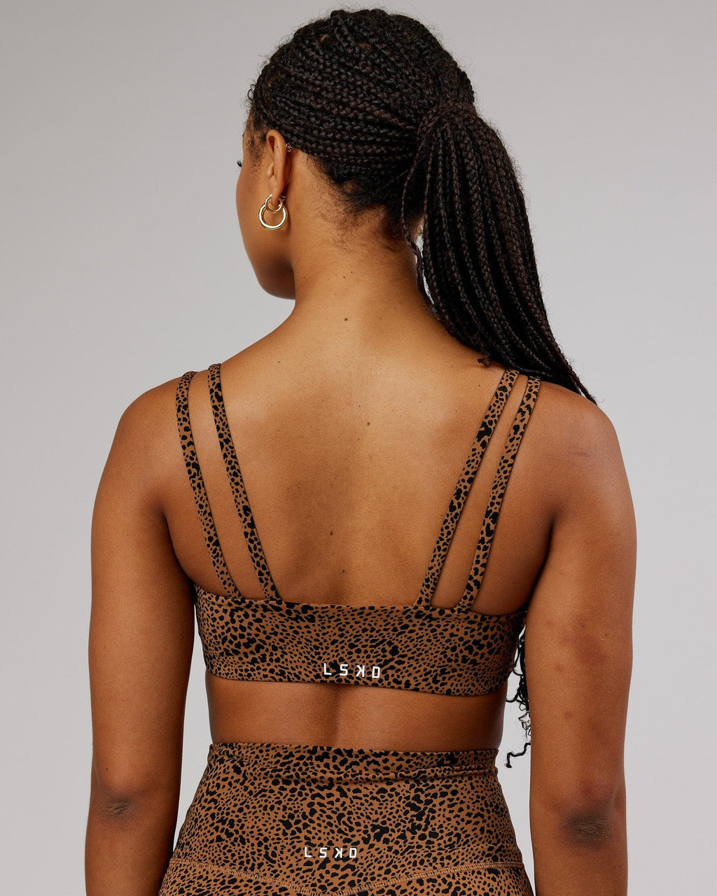 Model wearing Vogue Sports Bra - Agile Camel Print