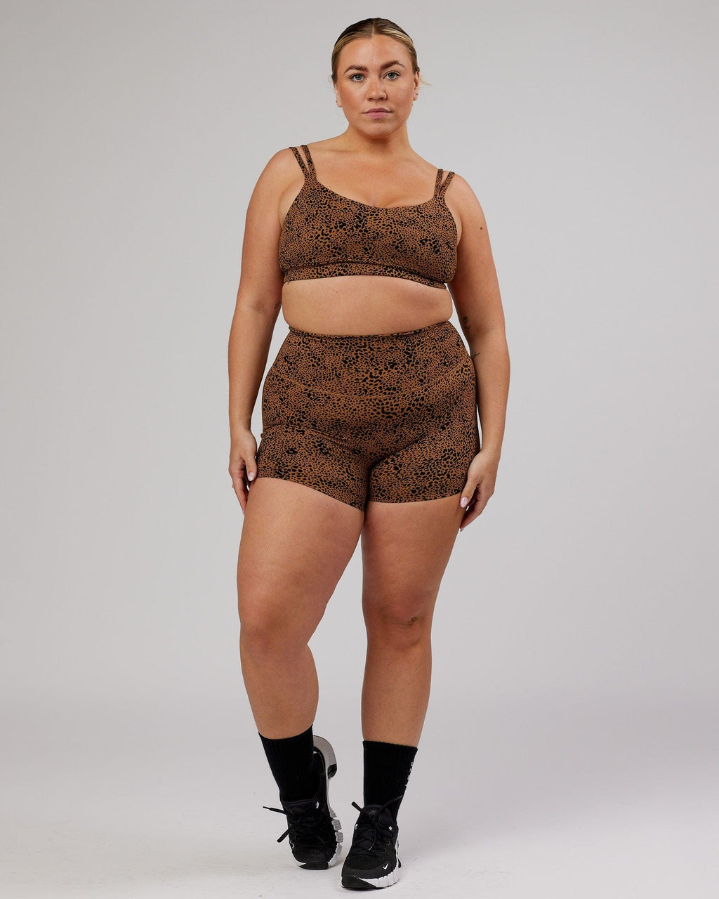 Model wearing Vogue Sports Bra - Agile Camel Print