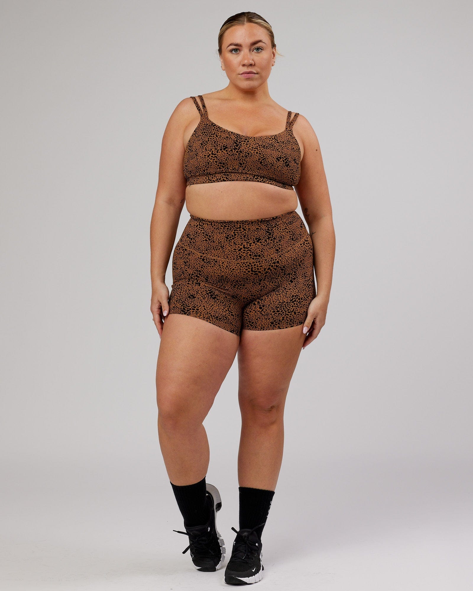 Model wearing Vogue Sports Bra - Agile Camel Print