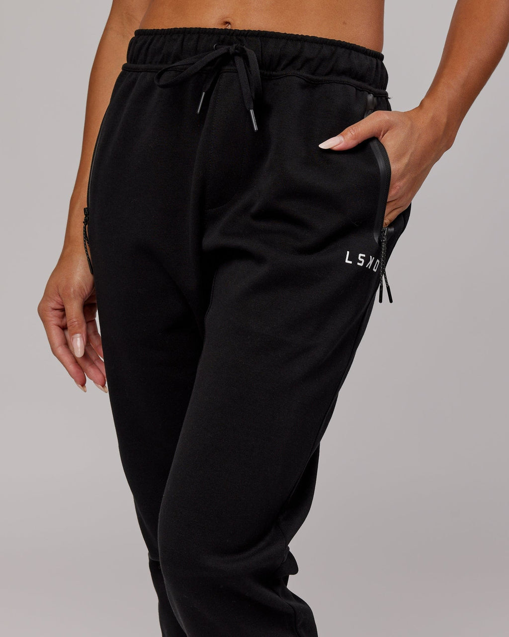 Model wearing Womens Athlete ForgedFleece Trackpant - Black
