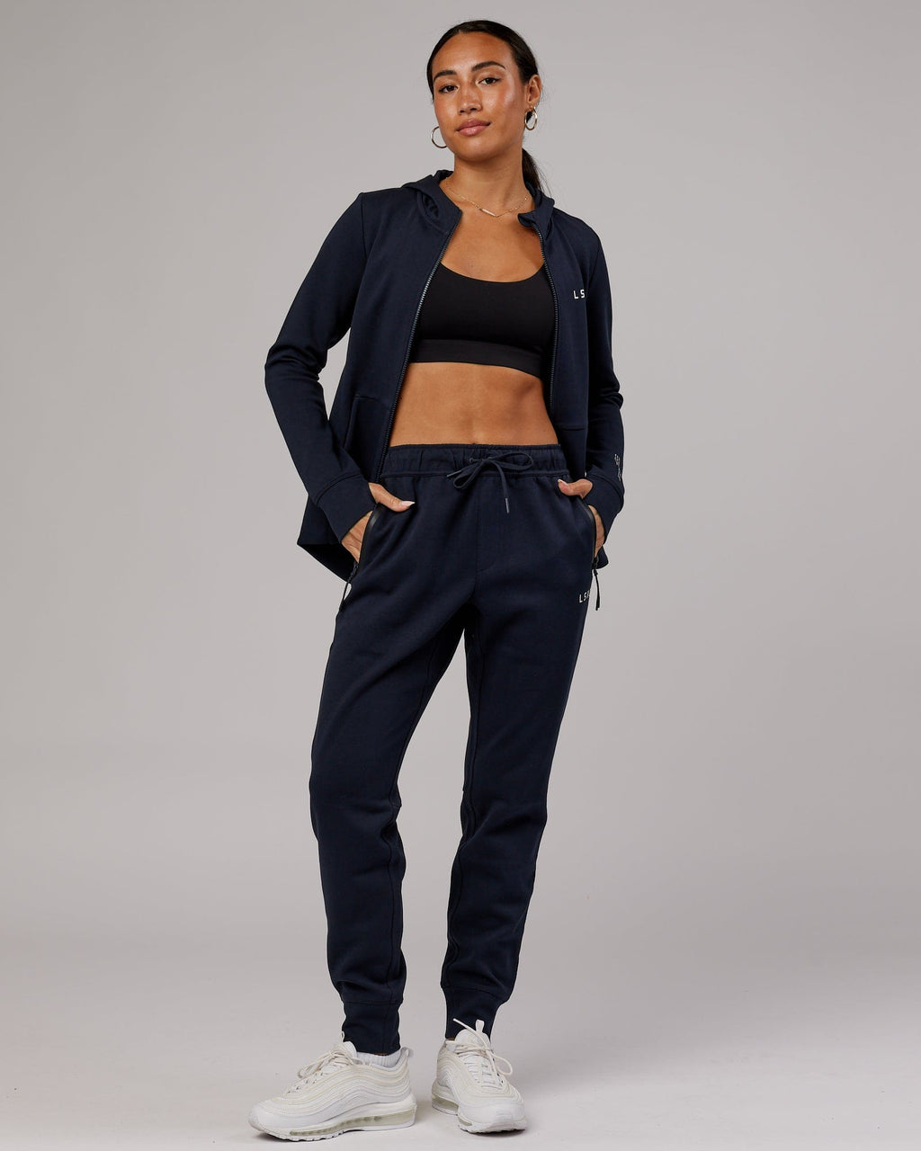Model wearing Womens Athlete ForgedFleece Trackpant - Dark Navy