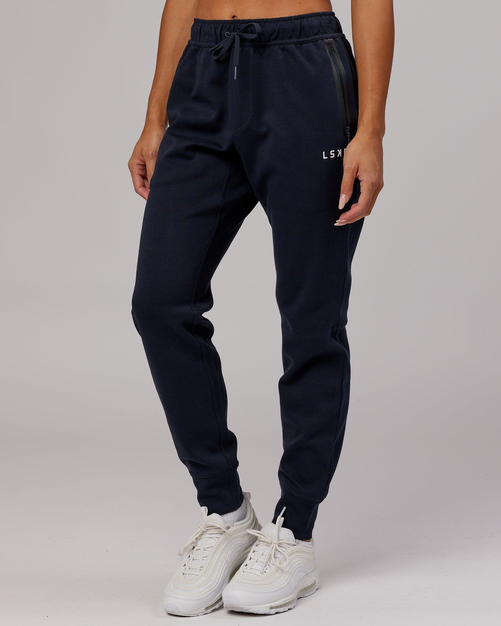 Model wearing Womens Athlete ForgedFleece Trackpant - Dark Navy
