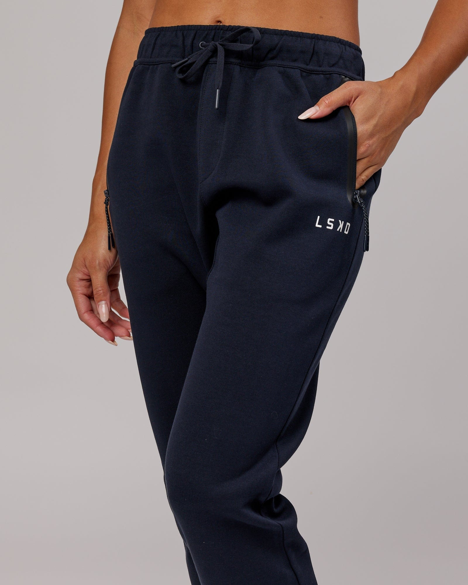 Model wearing Womens Athlete ForgedFleece Trackpant - Dark Navy