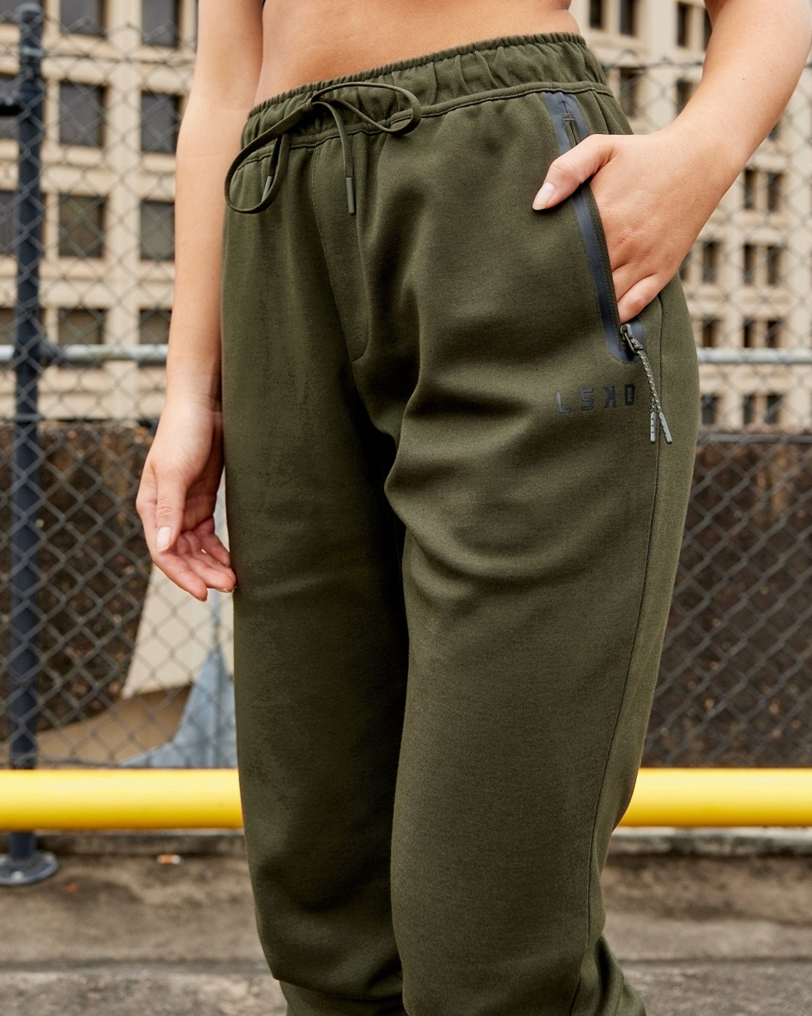 Model wearing Womens Athlete ForgedFleece Trackpant - Forest Night