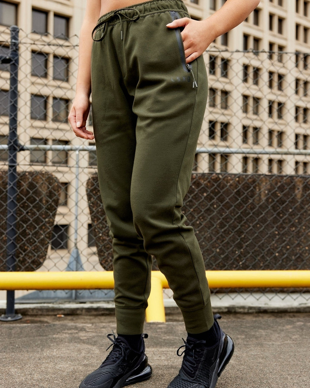 Model wearing Womens Athlete ForgedFleece Trackpant - Forest Night
