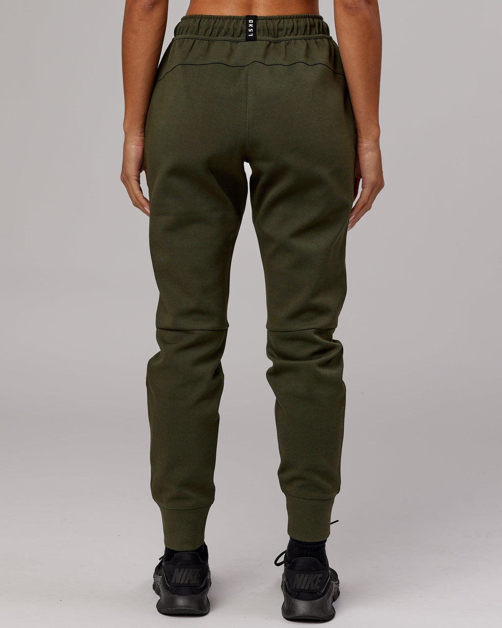 Model wearing Womens Athlete ForgedFleece Trackpant - Forest Night