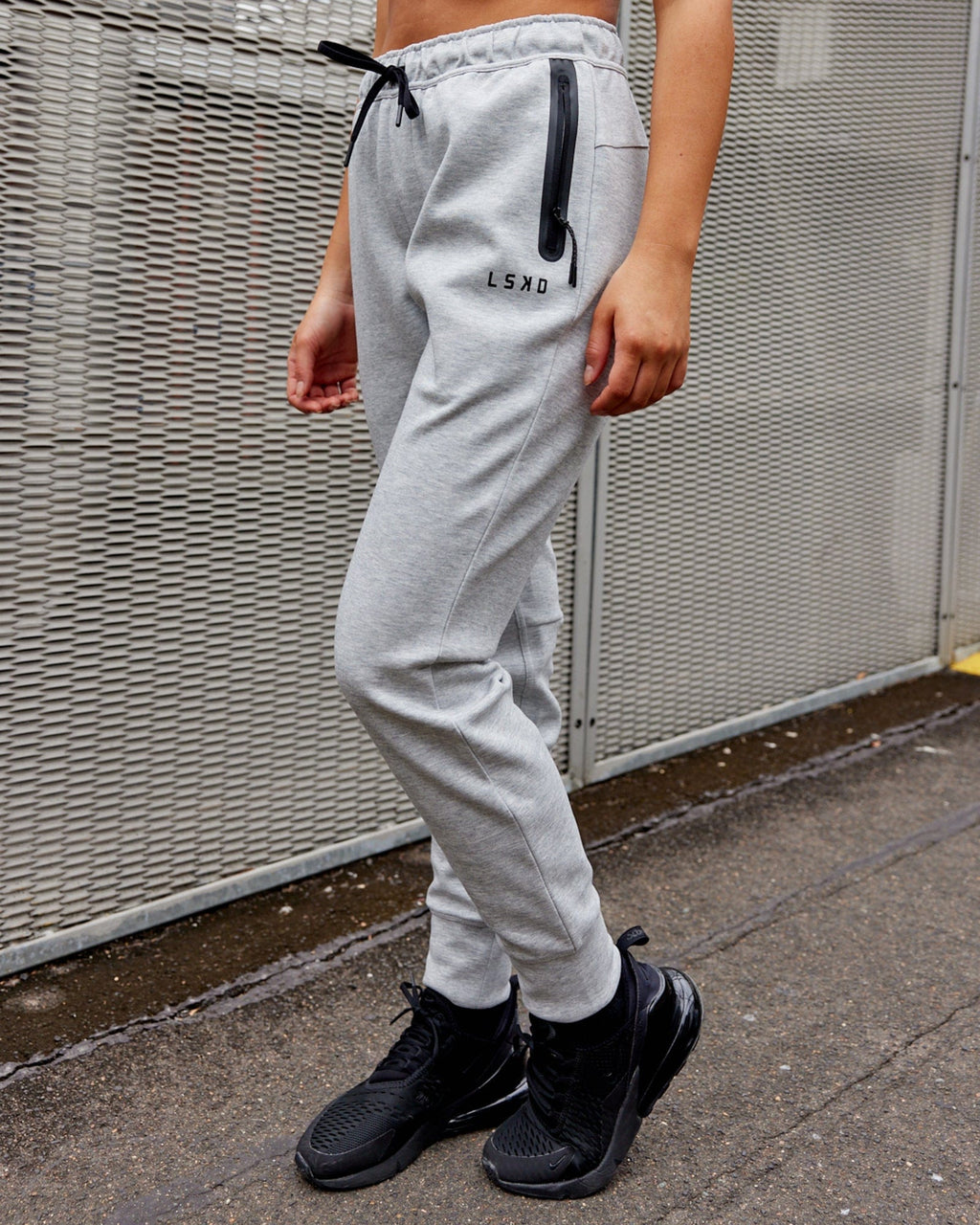 Model wearing Womens Athlete ForgedFleece Trackpant - Lt Grey Marl