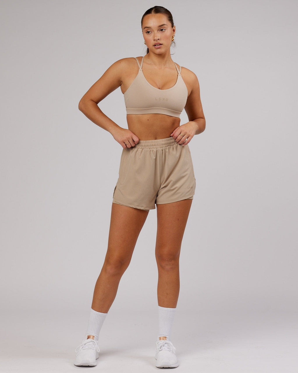 Model wearing Challenger Liner Run Short - Taupe