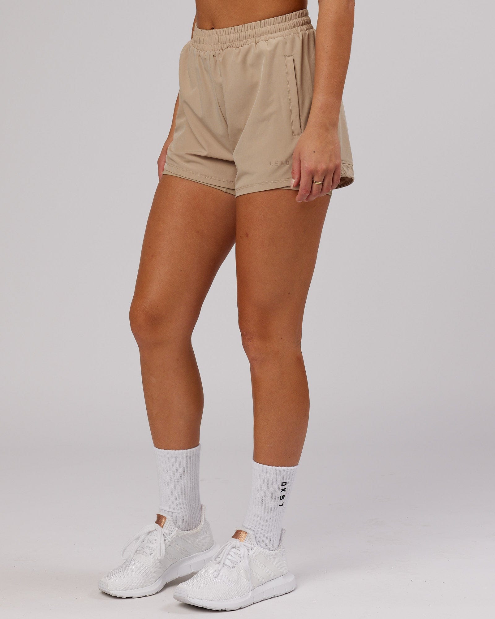 Model wearing Challenger Liner Run Short - Taupe