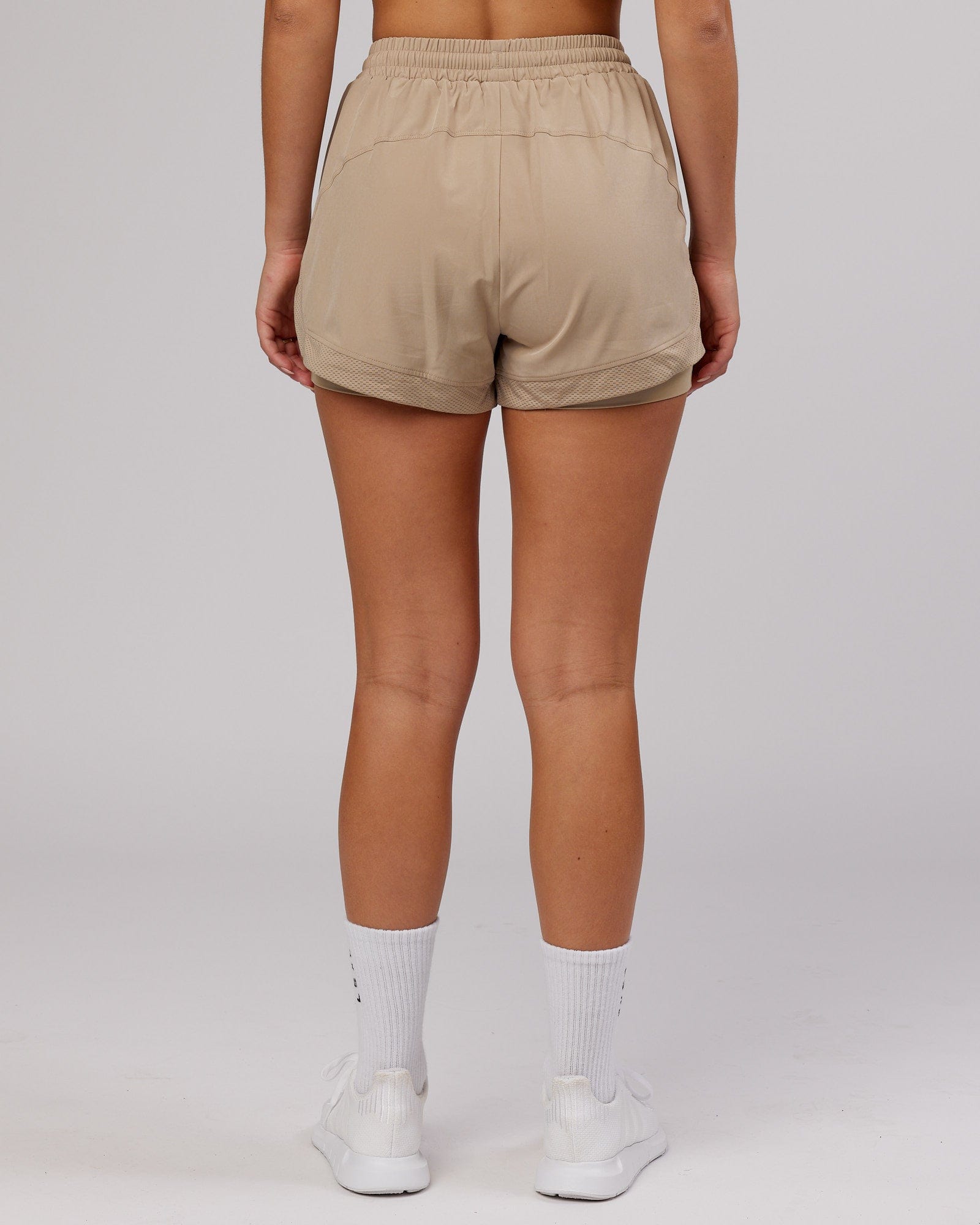 Model wearing Challenger Liner Run Short - Taupe