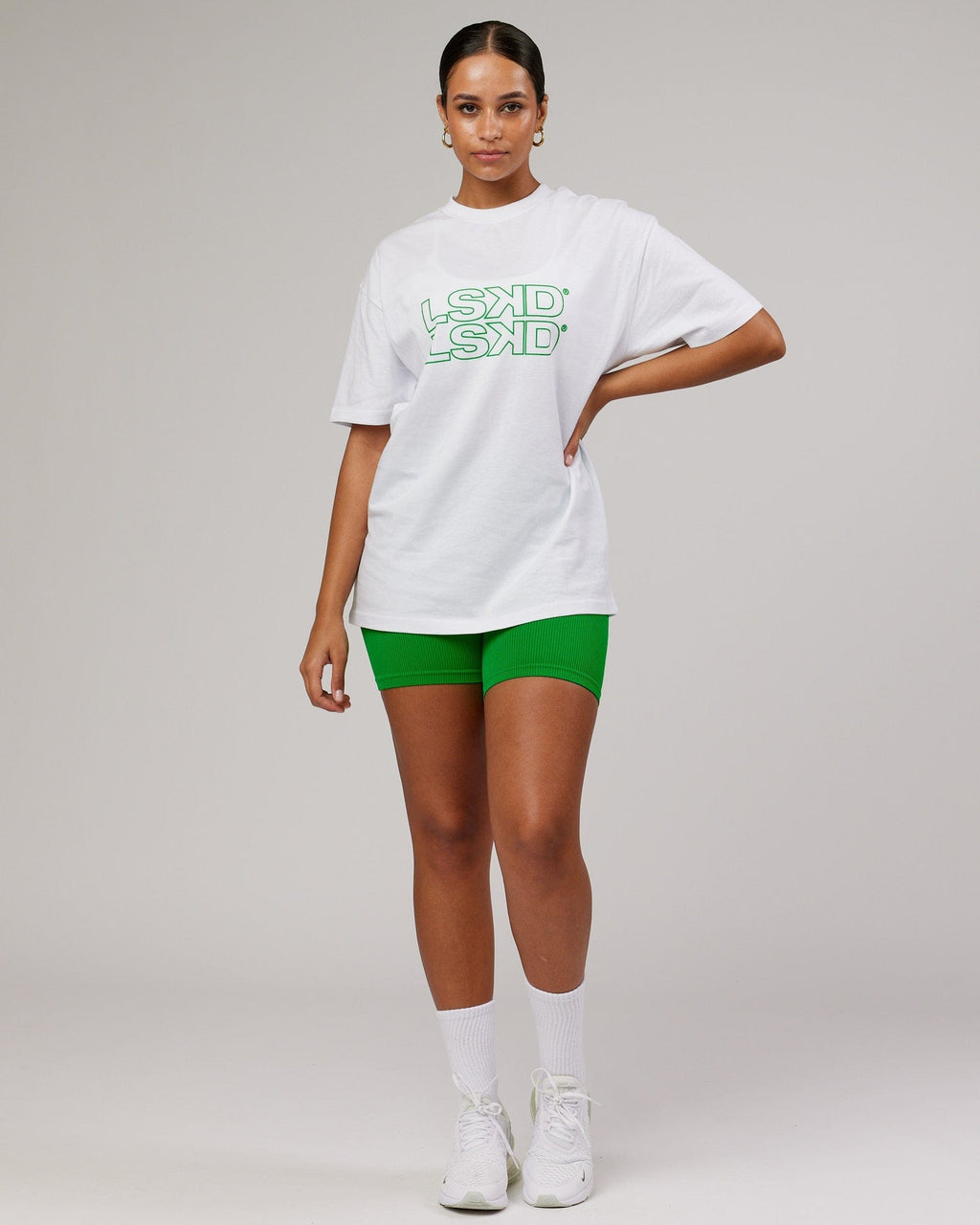 Model wearing Unisex Stacks Up Heavyweight Oversize Tee - White-Vivid Green