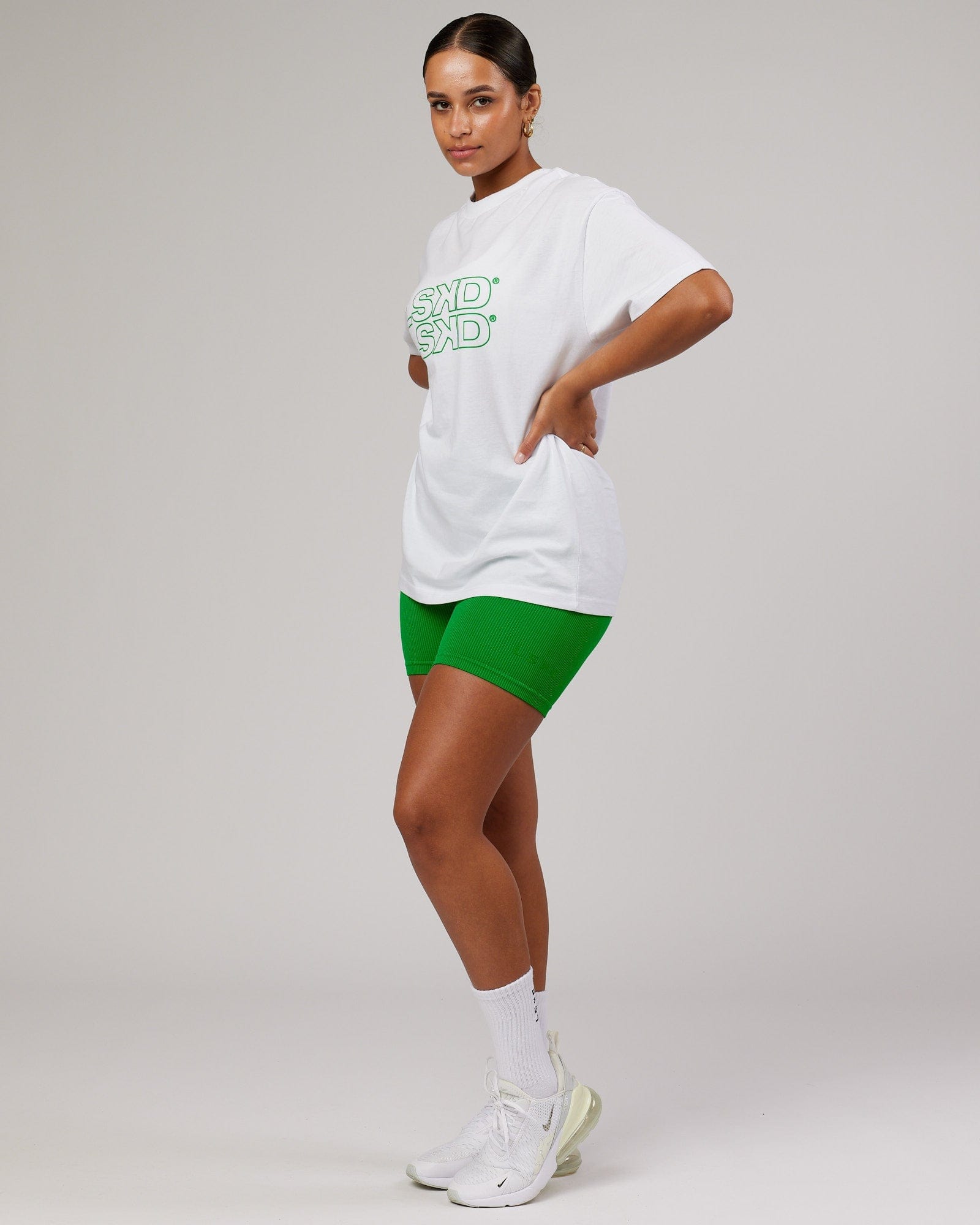 Model wearing Unisex Stacks Up Heavyweight Oversize Tee - White-Vivid Green