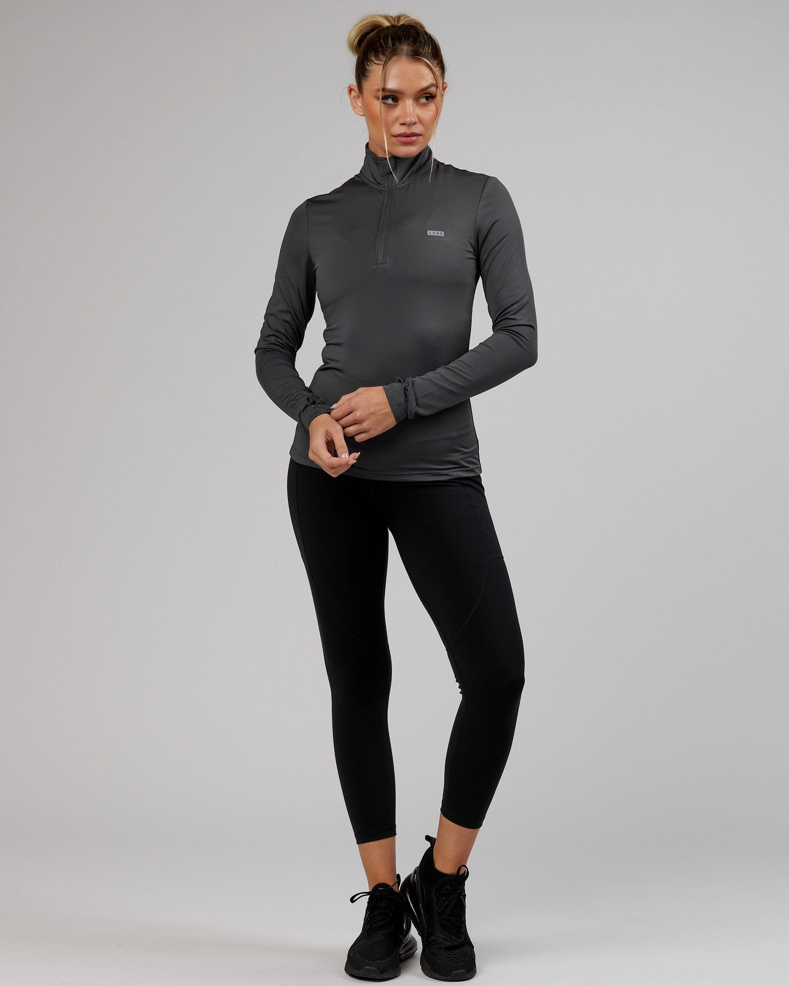 Model wearing Streamlined 1/4 Zip Active LS Top  - Asphalt
