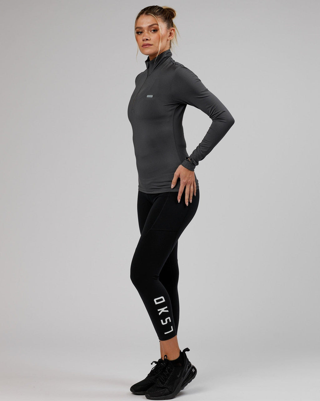 Model wearing Streamlined 1/4 Zip Active LS Top  - Asphalt