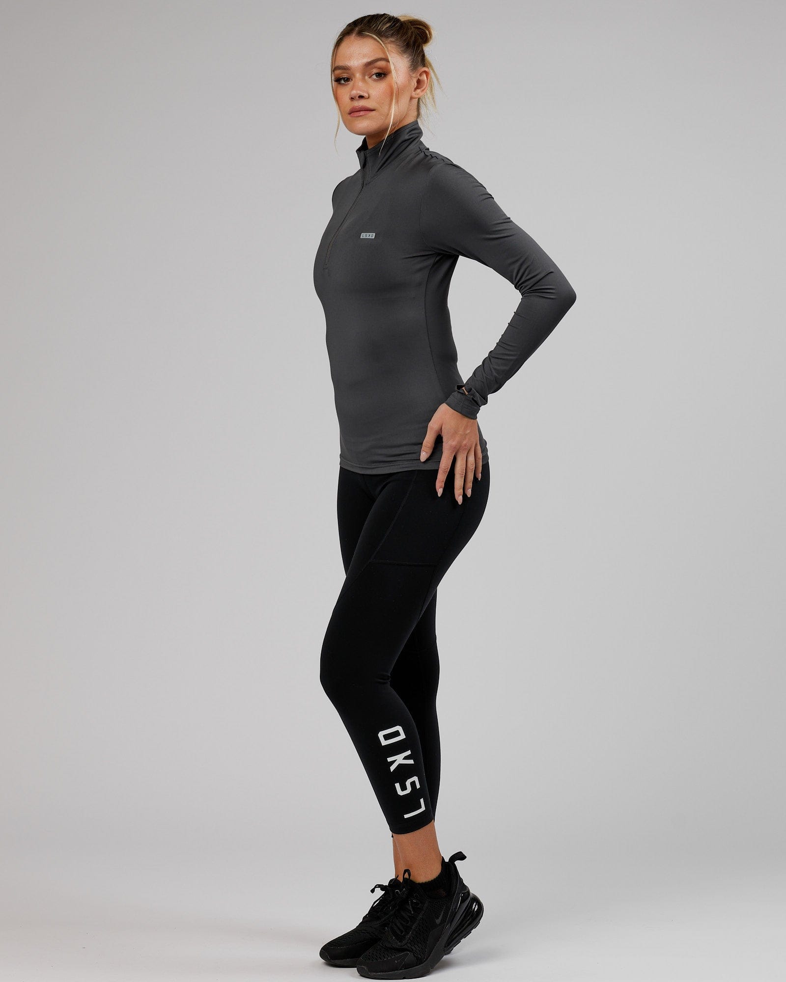 Model wearing Streamlined 1/4 Zip Active LS Top  - Asphalt