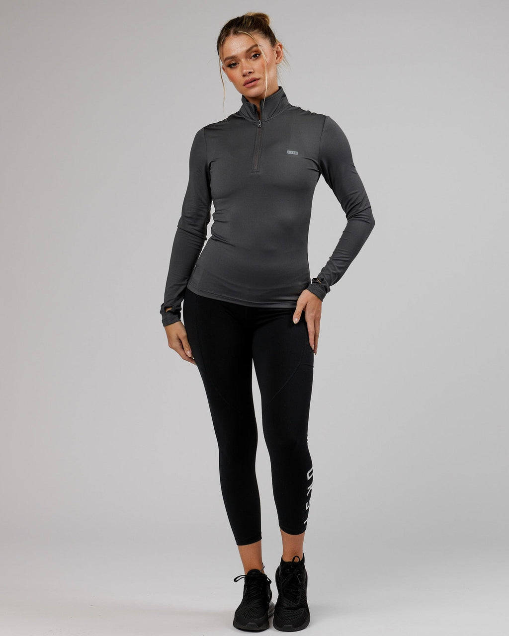 Model wearing Streamlined 1/4 Zip Active LS Top  - Asphalt