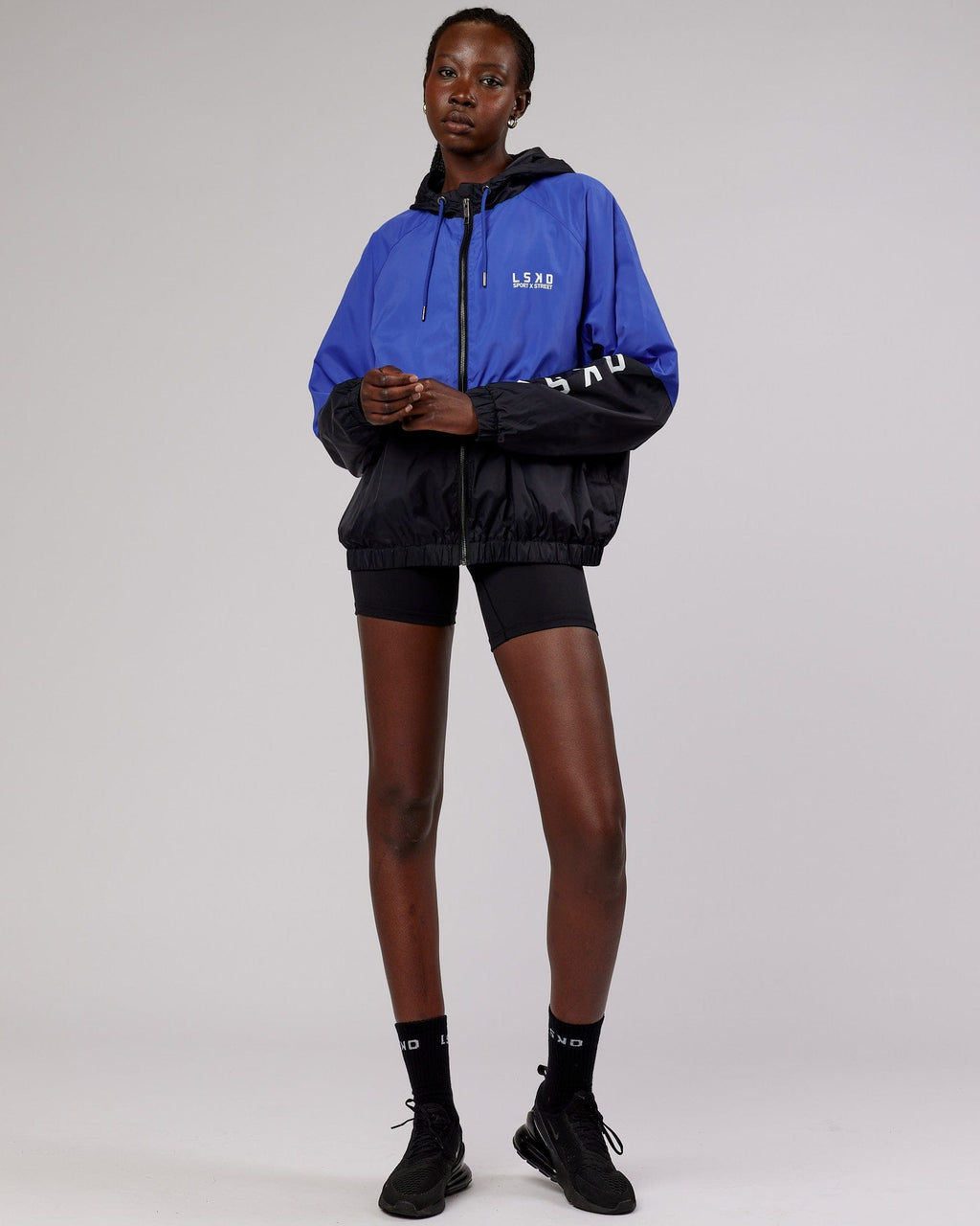 Model wearing Trackside Jacket - Power Cobalt