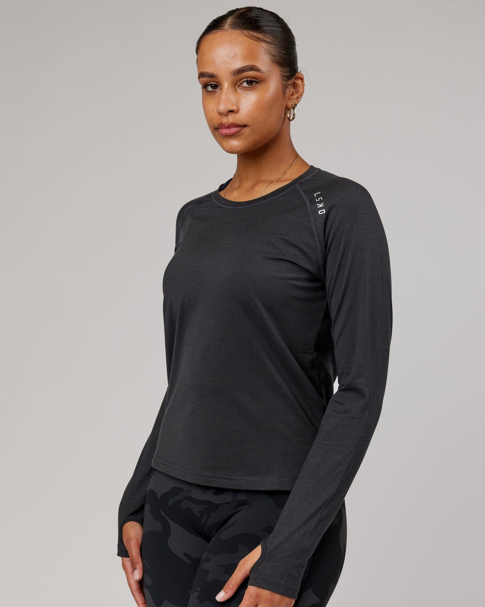 Model wearing Perform VapourFLX LS Tee - Black Marl